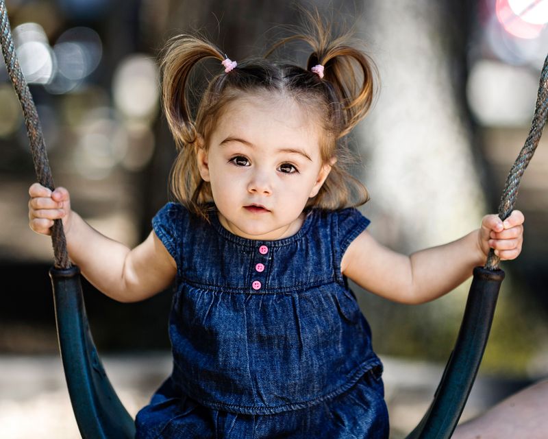 A girl riding on a seesaw